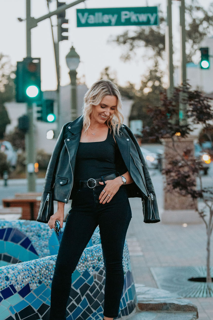 Fashion stylist Jaquelyn Wahidi reviews MOTHER Denim in front of a fountain.