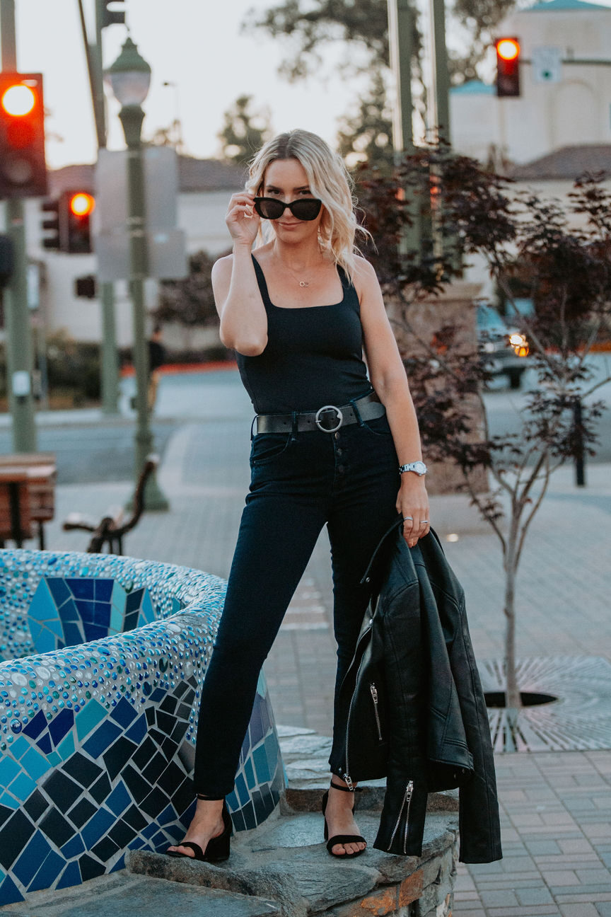 Personal stylist uses a leather jacket as a handbag.