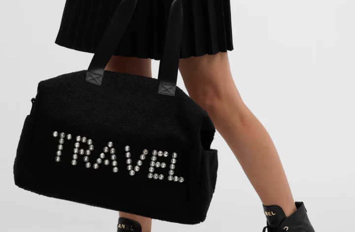 BTB Los Angeles Travel Bags in black faux fur with the word TRAVEL written in polycarbonate embellishments
