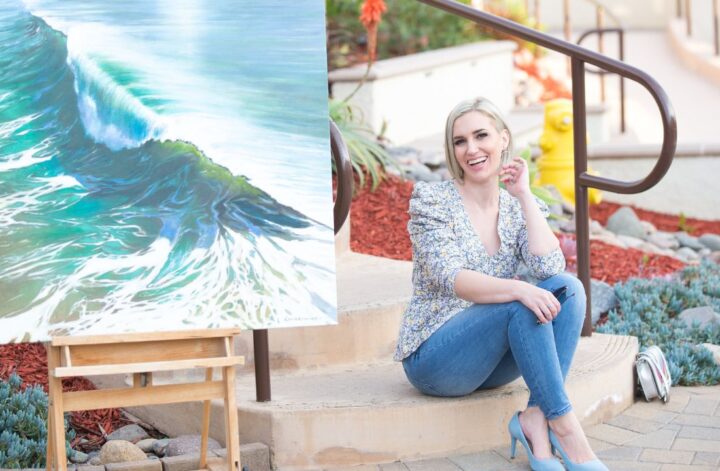 Personal Stylist Jaquelyn Wahidi wears a statement top in front of a painting in Solana Beach.